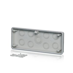 Ein Anbauflansch aus Polycarbonat mit Befestigungskeilen und Dichtungen hinter einem transparenten Hintergund.
